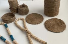 several wooden beads and rope on a white table with other wood bead items in the background