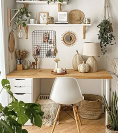 a desk with some plants and pictures on it