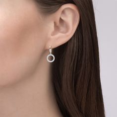 Crafted in sterling silver, each earring showcases a doughnut-like circle set with glistening small stones and linked in a dangling style. A smart choice for both day and night, these drop earrings fit any occasion and draw all the right kinds of attention. Polished to a bright shine, this chic pair of earrings is sure to be your contemporary classic.  Carat Weight: 1.28 ctStone Size: 1 mmStone Type: Jeulia® StoneNumber of Stones: 128 Stone Shape: RoundStone Color: Diamond WhiteWeight: 3.75 gWid Sterling Silver Drop Earrings, Stunning Earrings, Silver Drop Earrings, Online Earrings, Gold Platinum, Pear Cut, Quality Jewelry, Oval Cut, Wedding Accessories