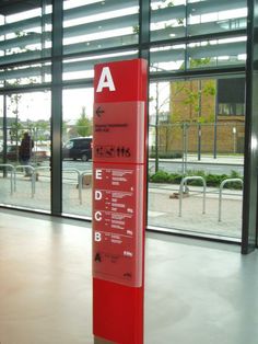 a red sign in front of a large window