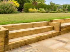 some wooden steps in the middle of a grassy area