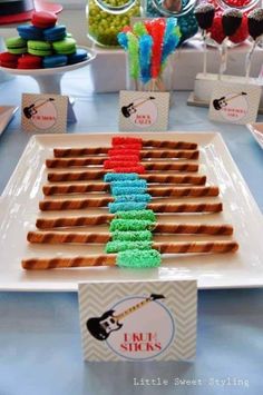 there is a plate that has some food on it and candy sticks in the shape of a christmas tree