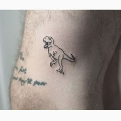 a man with a small dinosaur tattoo on his chest