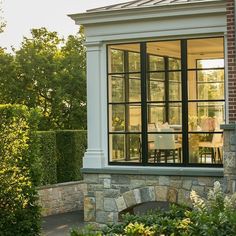 an outside view of a house with glass windows