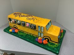 a yellow school bus cake with animals on it's side and the words happy birthday gig