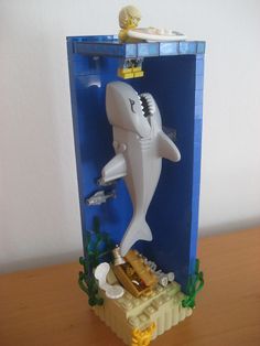 a lego shark in a box on top of a table