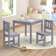 a child's table and two chairs in a room