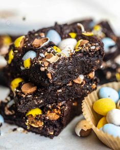 chocolate brownies with m & m candies on the top and one half eaten