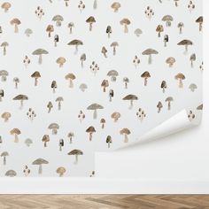 a white wall with mushrooms on it and a wooden floor in front of the wall