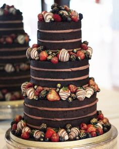 a triple layer chocolate cake with strawberries on top