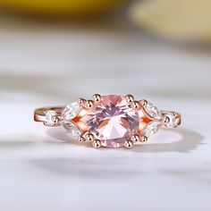 Indulge in the ethereal beauty of the morganite ring, a stunning masterpiece that captures hearts and captivates souls. Crafted with a captivating round-cut morganite as its centerpiece, this ring exudes timeless beauty. The delicate blush hue of the morganite is complemented by the dazzling brilliance of the marquise-cut white stones that gracefully adorn its sides. Embrace the allure of this enchanting piece, where the soft pink hues of the morganite symbolize love and compassion, while the sp Elegant Morganite Solitaire Diamond Ring, Elegant Morganite Solitaire Rings, Elegant Solitaire Morganite Rings, Exquisite Morganite Rose Gold Rings, Fine Jewelry Morganite Diamond Ring In Rose Gold, Exquisite Morganite Diamond Ring For Anniversary, Exquisite Rose Gold Morganite Ring, Fine Jewelry Rose Gold Morganite Diamond Ring, Elegant Morganite Diamond Ring With Round Cut