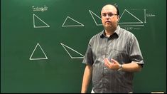 a man standing in front of a blackboard with three triangles on it and one has his hand out