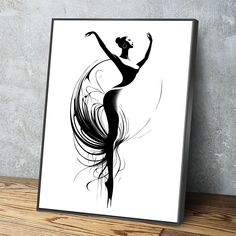 a black and white drawing of a ballerina on a wooden table next to a wall