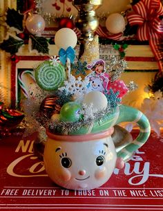 a coffee mug with christmas decorations on it