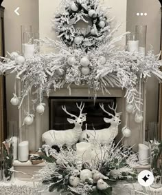 a fireplace decorated with silver and white christmas decorations