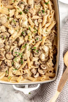 a casserole dish filled with pasta and mushrooms