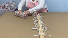 a woman working on some kind of crafting project with tape and spools