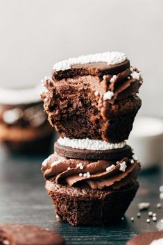 three chocolate cupcakes stacked on top of each other