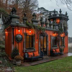 an orange shipping container with lots of windows and lights on the roof is lit up at night