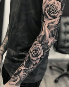 a man's arm with roses on it