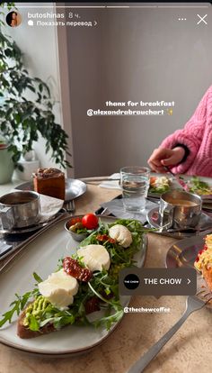 a person sitting at a table with food on it