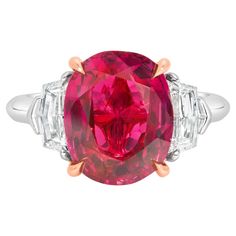 A gorgeous engagement ring, featuring a 4.91 carats oval cut ruby, set on a classic four prong basket made of 14K rose gold. Flanked by epaulette cut diamonds weighing 0.81 carat total. Elegantly made with a platinum mounting. Size 6.5 US, resizable upon request.  Roman Malakov is a custom house, specializing in creating anything you can imagine. If you would like to receive a special quote on a custom piece, please message or call us. Star Ruby Ring, Ruby Set, Contemporary Engagement Rings, Oval Diamond Engagement, Modern Engagement Rings, Gorgeous Engagement Ring, Claw Prong, Jewels Rings, Custom House