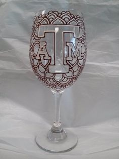 a wine glass with the letter t painted on it