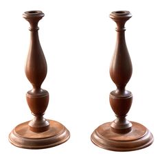 two wooden candlesticks sitting next to each other