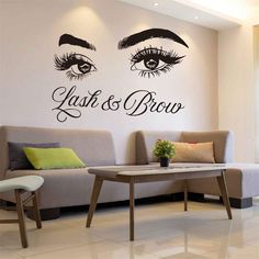 a living room with two wall decals that say lashes and brows