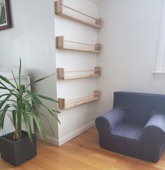 a blue chair sitting next to a plant in a living room