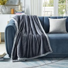 a blue couch with a blanket on it