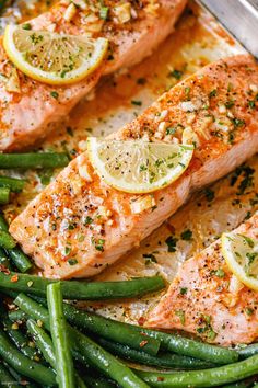 salmon, green beans and lemon slices on a pan