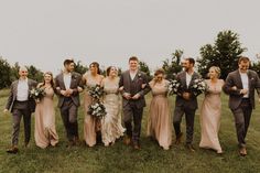 a group of people standing next to each other on top of a lush green field