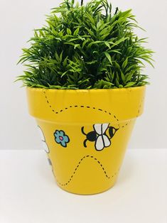 a potted plant with bees painted on it