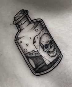 a skull in a bottle tattoo on the chest