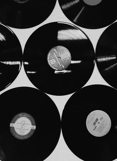 black and white photograph of records stacked on top of each other