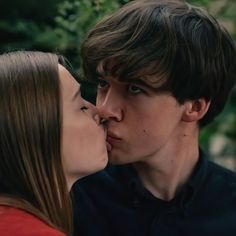 a young man and woman kissing each other