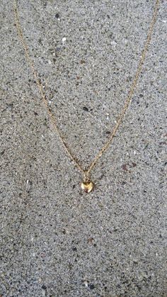 "Beautiful. Delicate Tiny gold 6mm (0.23 inches) puffed heart hangs delicately from a gold fill chain. The heart is puffed on both sides and hollow in the center. Made from high quality tarnish resistant gold fill. Shown here in 16\" length. *If you are unsure of the length you need, or would like to wear this item at different lengths, we now offer an adjustable length option! You can add an adjustable end to your necklace using this link: https://www.etsy.com/listing/791277751/necklace-extensi 14k Gold-filled Heart Necklace With Heart Charm, Gold Double Heart Charm Necklace, Tiny Dainty Heart Necklace, Gold Heart Charm Necklaces With Heart Cut, Gold Heart Charm Necklaces, Gold Heart Cut Charm Necklace, Gold Minimalist Heart Beads Necklace, Dainty Tiny Heart Necklace, Everyday Delicate Gold Heart Necklace