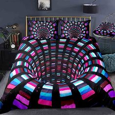 a bed covered in a colorful comforter and pillows