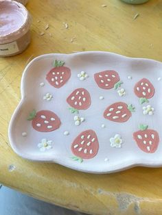 a plate with strawberries on it sitting on a table