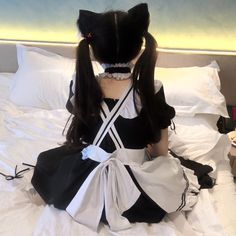 a black and white dress sitting on top of a bed