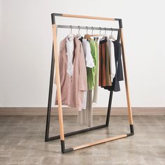 a clothes rack with several shirts hanging on hangers