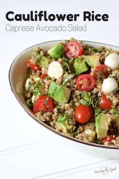 a bowl filled with rice and veggies on top of a white tablecloth