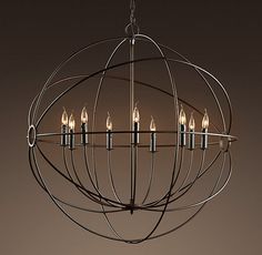 a chandelier with eight lit candles hanging from it's center, on a dark background