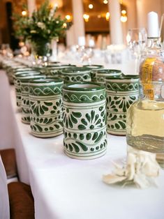 several green cups sitting on top of a white table