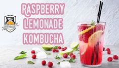 raspberry lemonade kombucha with limes and ice cubes