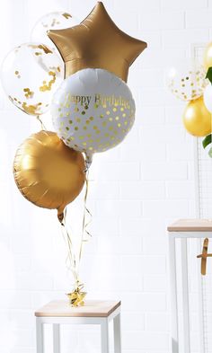 a bunch of balloons that say happy birthday with gold and white confetti on them