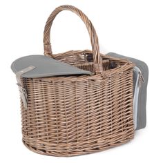 a wicker basket with grey linings and handles on the bottom, holding a purse