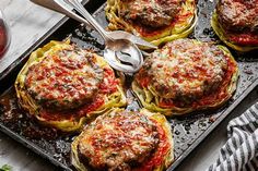 an overhead view of some food on a tray with utensils and spoons