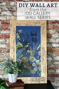 an old frame with flowers and plants on it in front of a brick wall that reads diy wall art from the 10d gallery walls